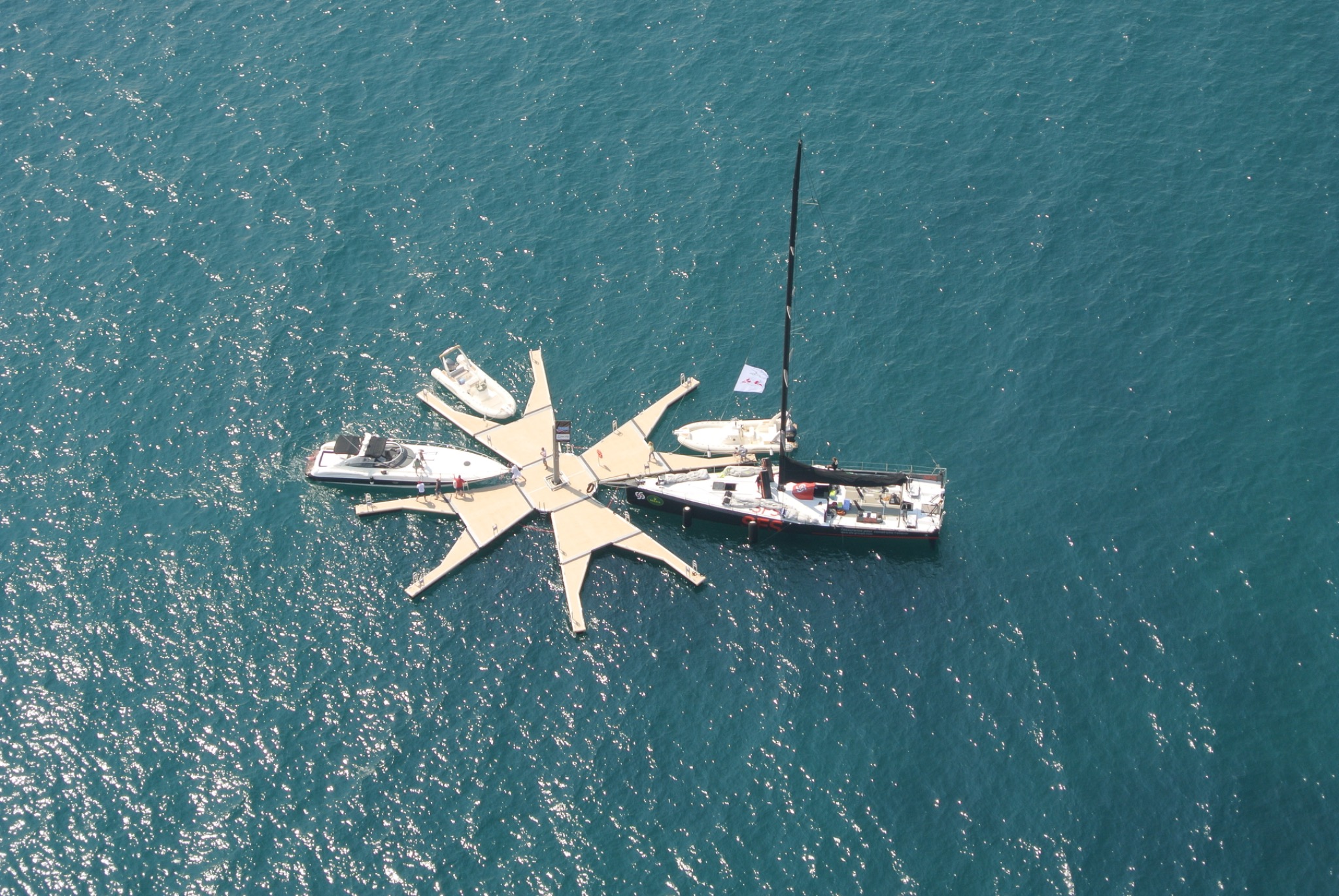 Aerial view of SEAFLOATECH Prototype No. 1 at sea with several boats alongside